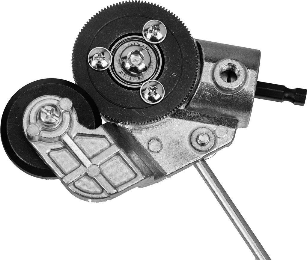 A close-up view of a metal and plastic mechanical adapter with gears and wheels.