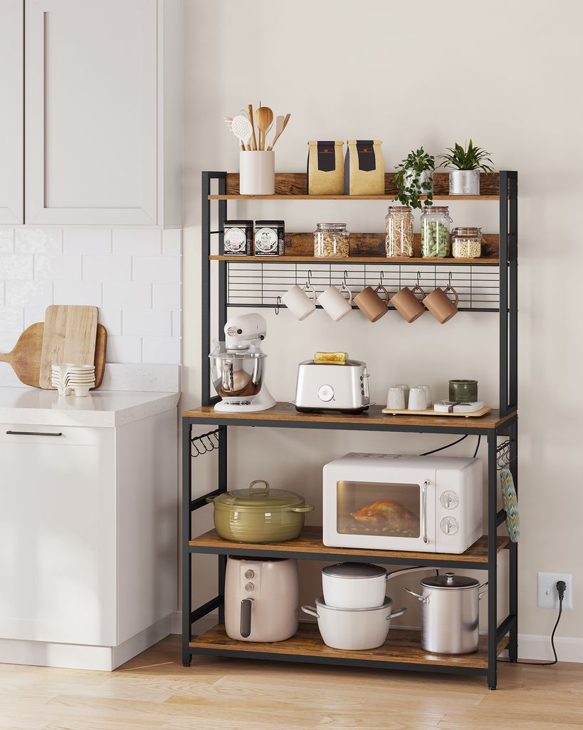 A kitchen scene featuring a microwave rack filled with kitchen appliances and cookware.