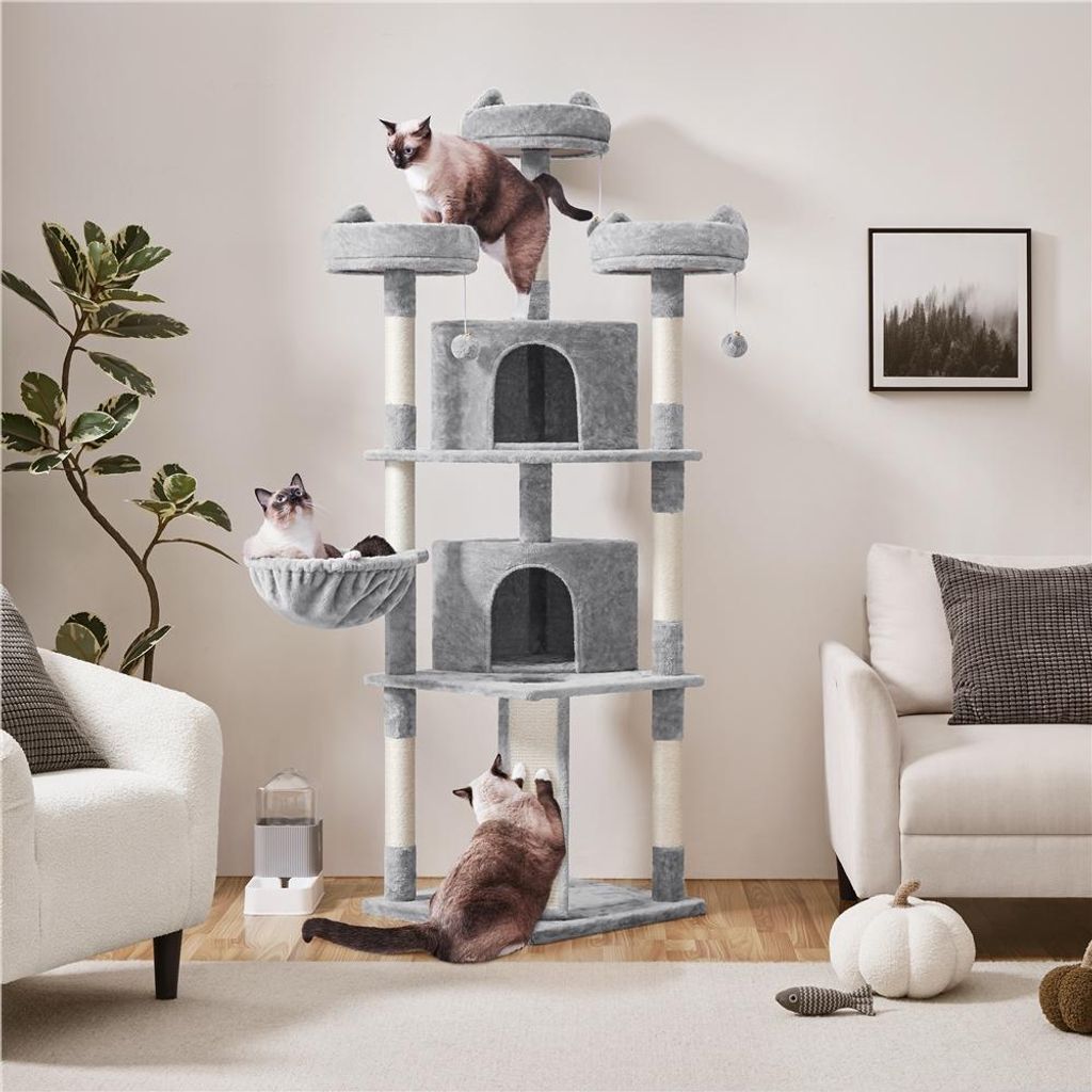 A multi-level cat tree with several cats interacting with it, placed in a living room setting.