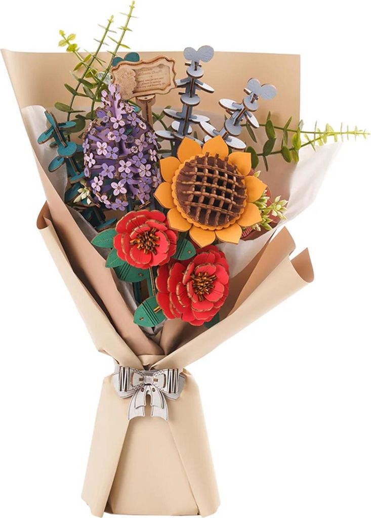 A 3D wooden puzzle bouquet of flowers, wrapped in brown paper and tied with a silver bow.