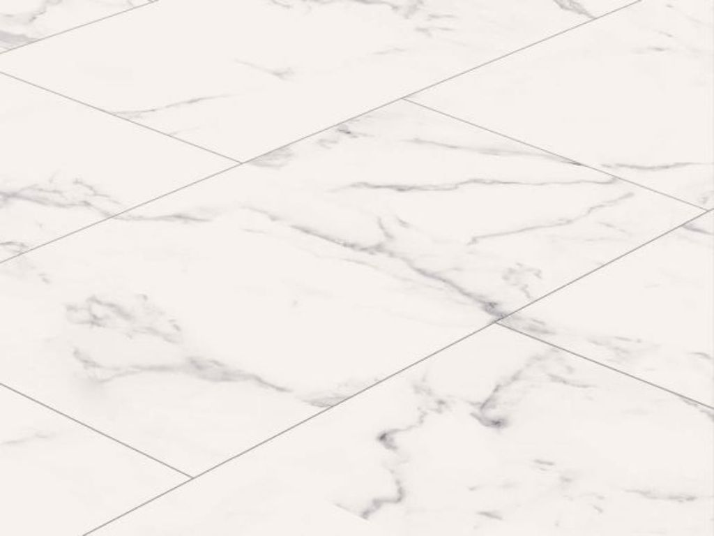 A close-up, angled view of white marble-patterned vinyl flooring tiles.
