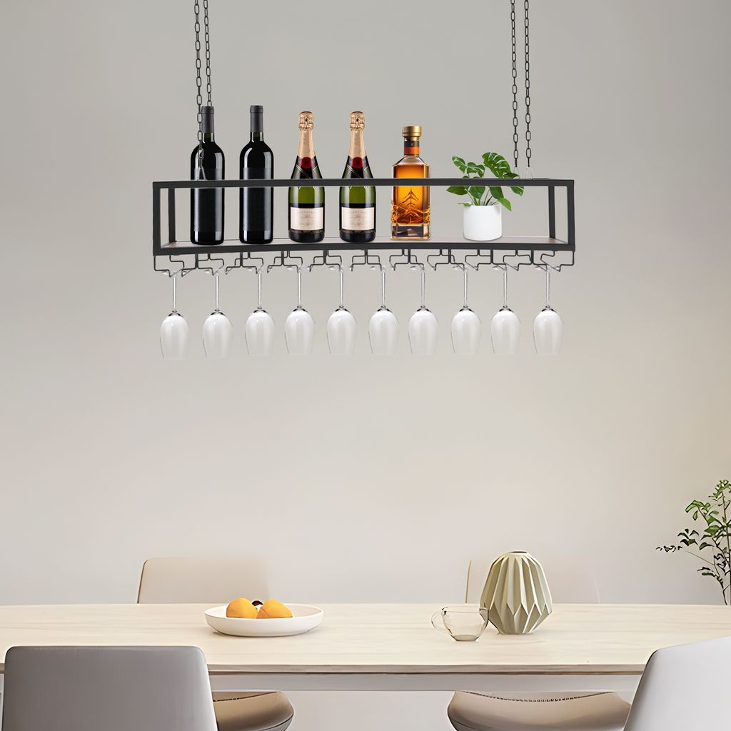A hanging wine rack with bottles and glasses above a dining table.