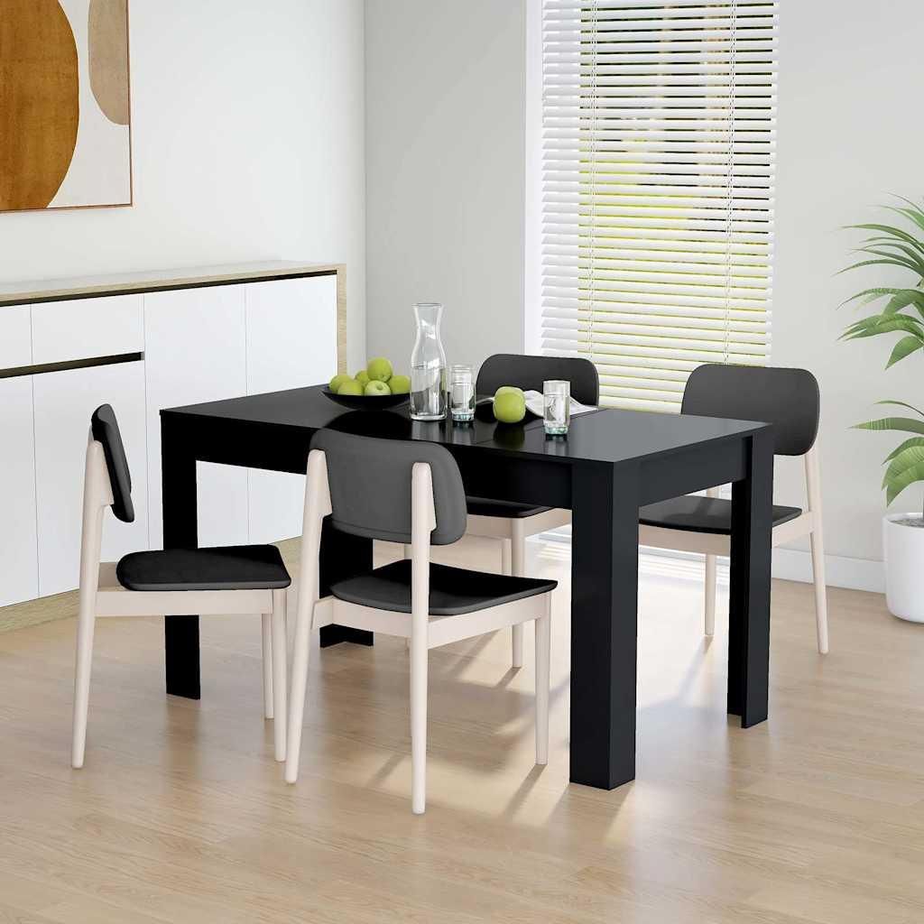 A dining table and chairs set in a bright room.