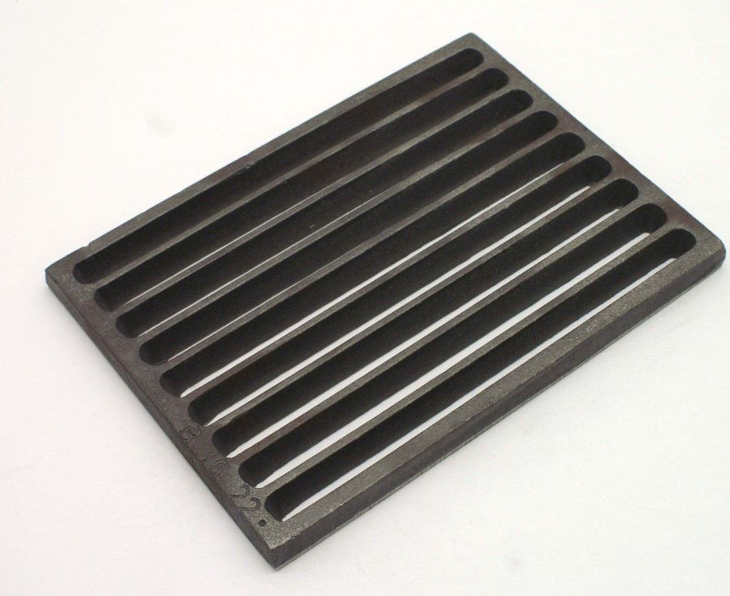 A dark gray, rectangular grate with multiple parallel slots is shown on a white background.