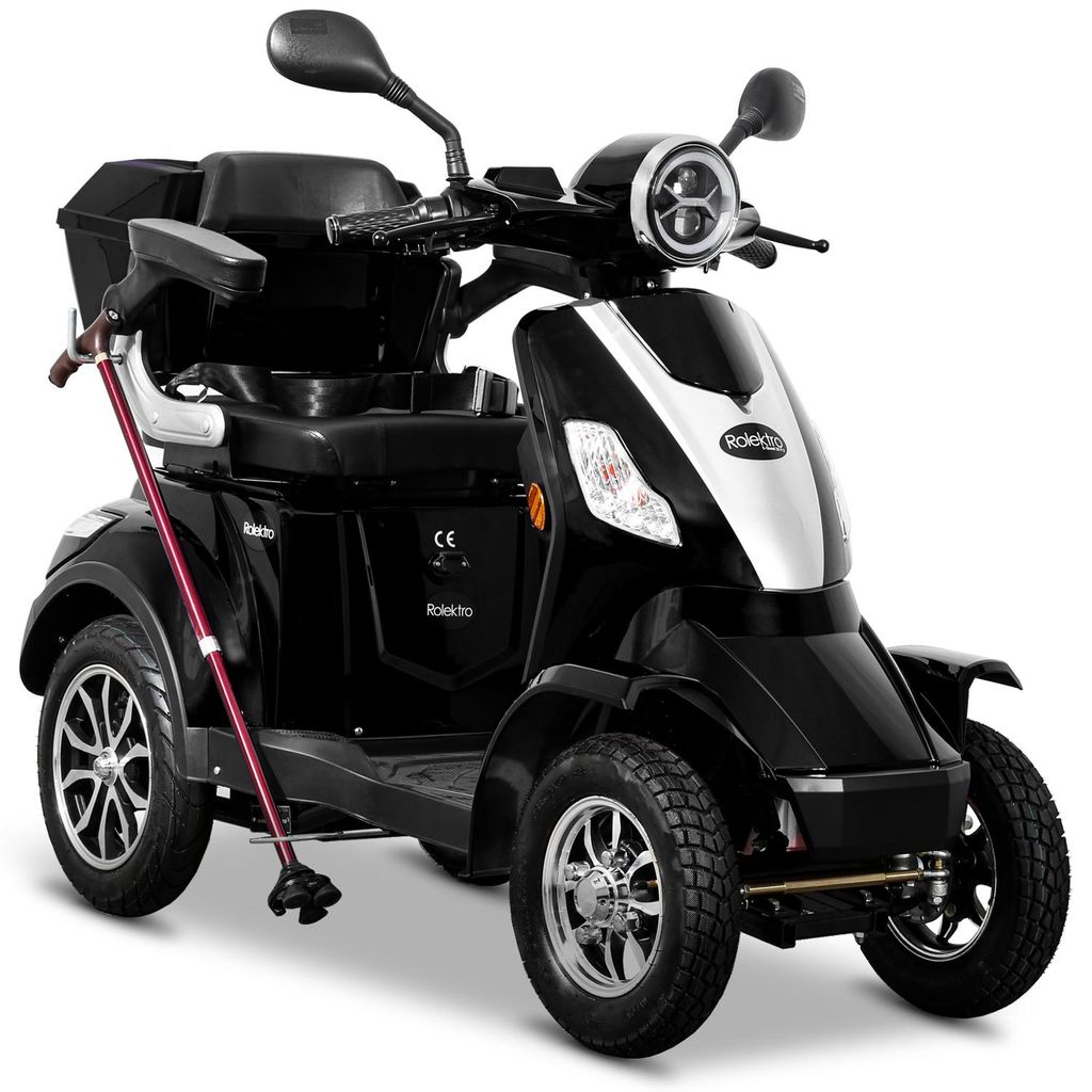 A black and silver electric scooter with a cane attached.