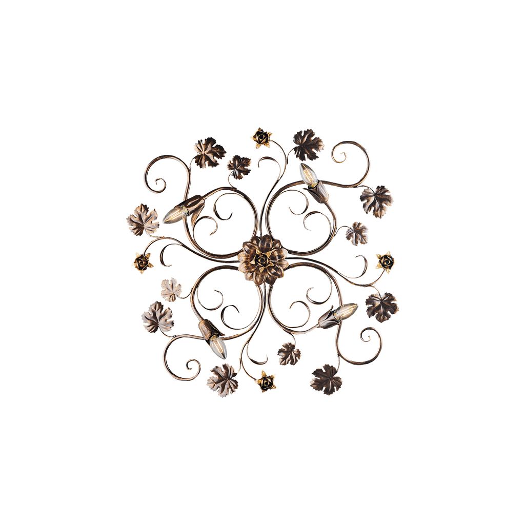 A decorative metal wall art piece with floral and vine motifs.