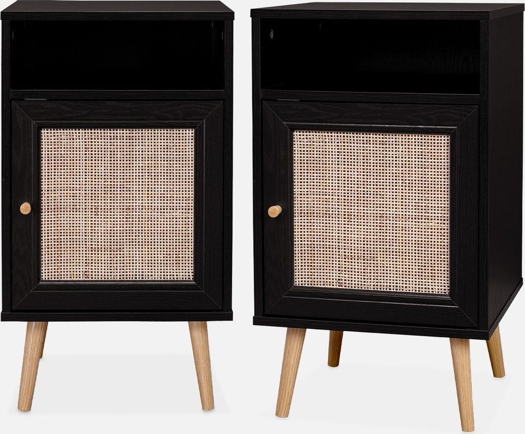 Two black bedside tables with rattan fronts and wooden legs.