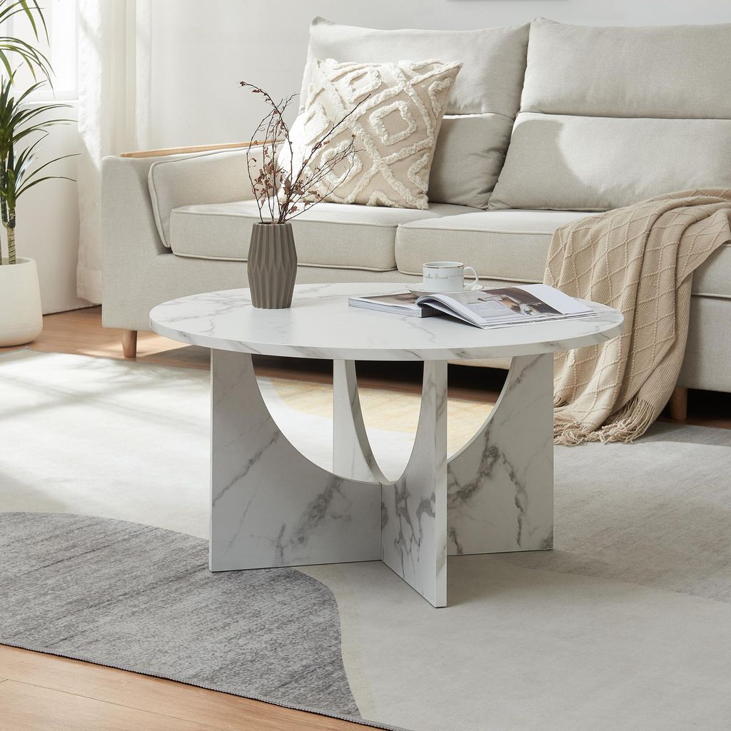 A living room scene with a couch, coffee table, and rug.