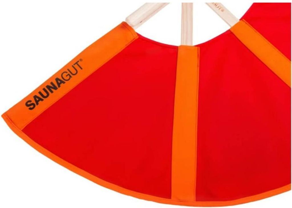 A close-up of a red and orange fan-like object with wooden handles.