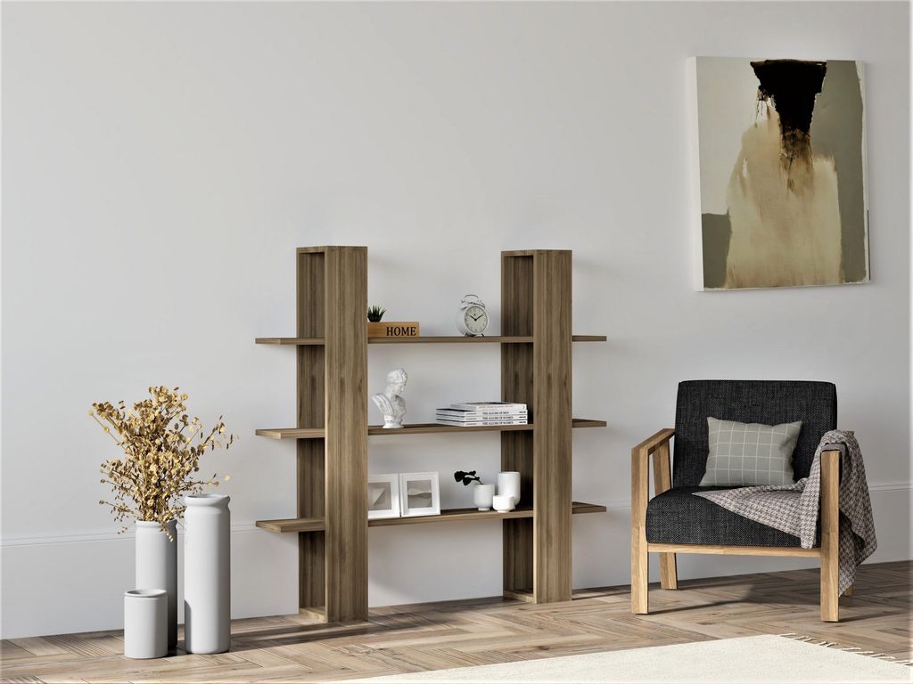 A modern living room scene with a bookshelf, chair, and artwork.