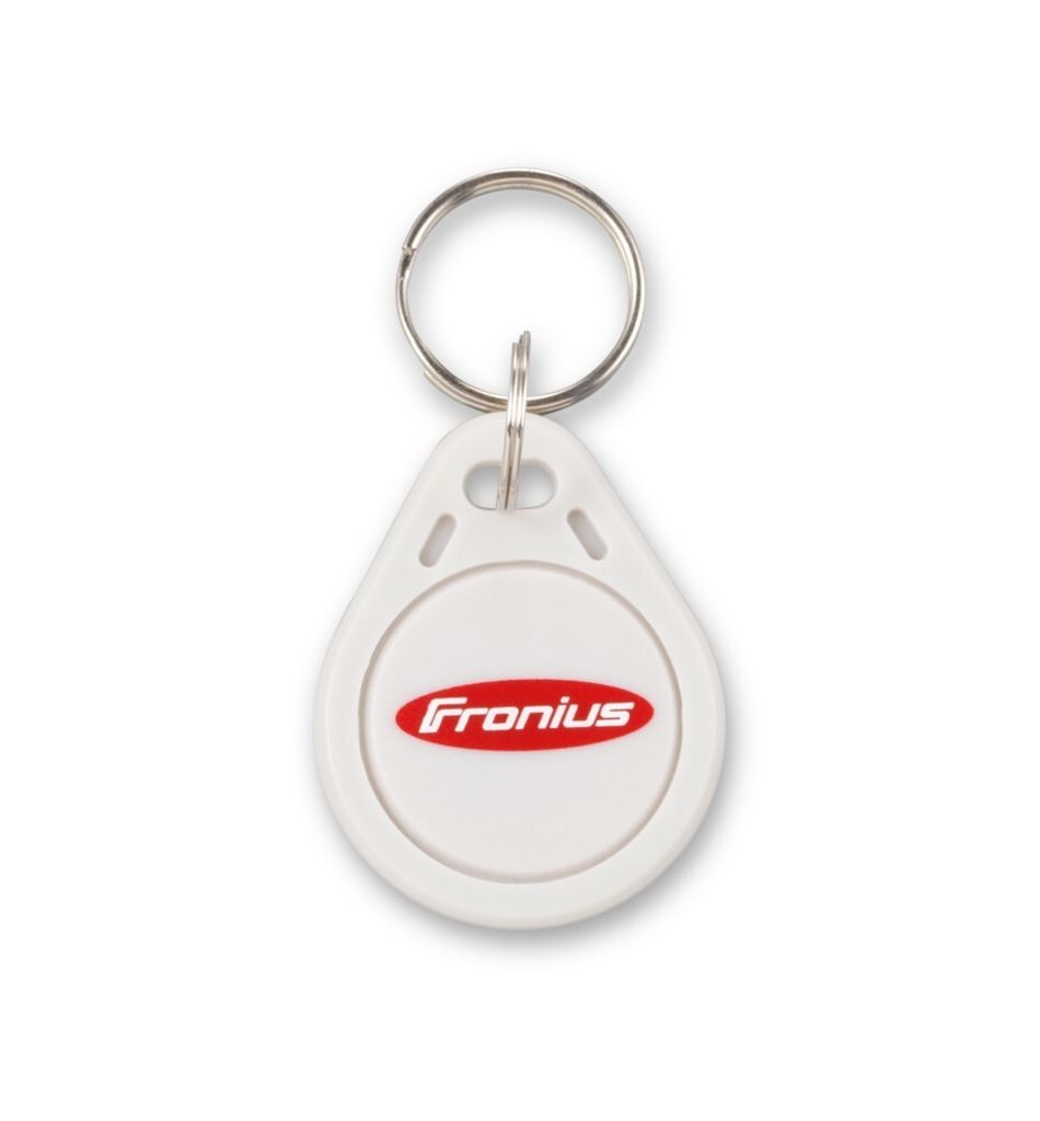 A white key fob with a red logo is shown.