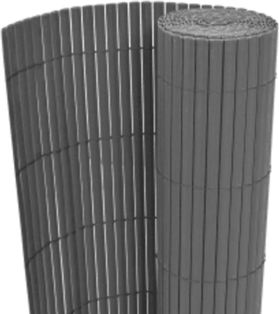 A rolled-up and unrolled section of a gray garden fence made of vertical slats.