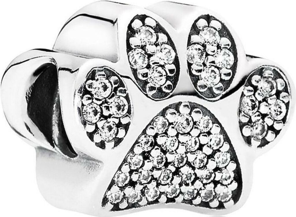 A close-up studio shot of a silver paw print charm with clear cubic zirconia stones.