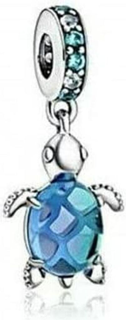 A close-up studio shot of a Pandora charm shaped like a turtle.