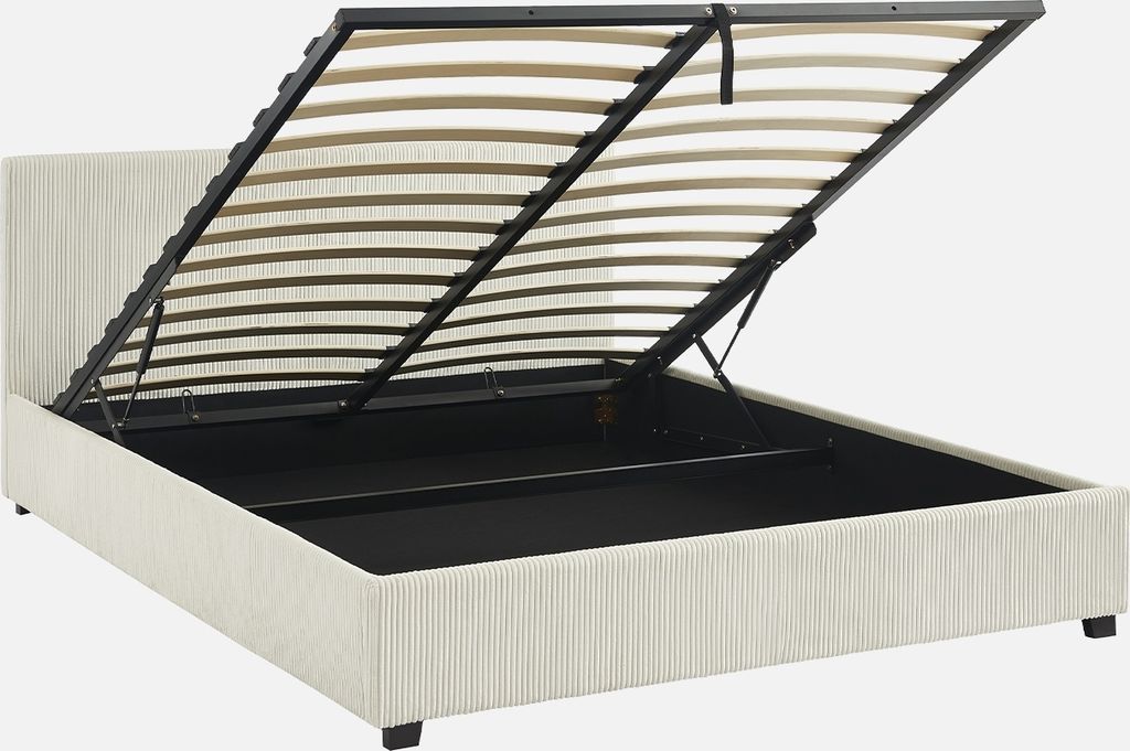 A bed frame with the mattress support system lifted to reveal storage space underneath.