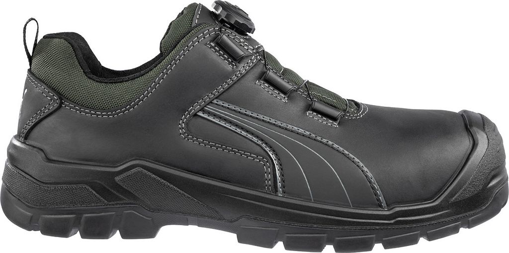 A side view of a black safety shoe with green accents.