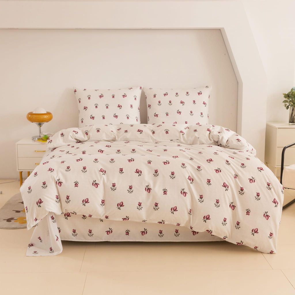 A neatly made bed with floral patterned bedding.