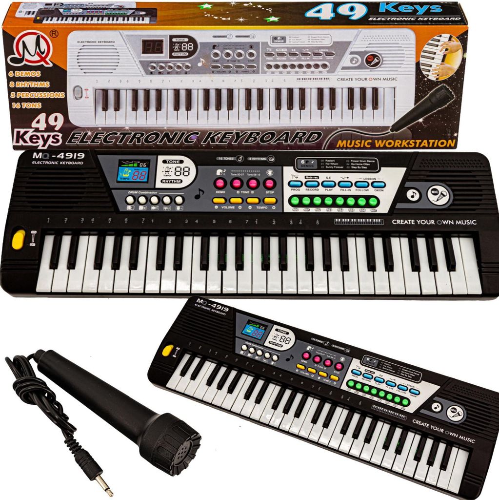 A product shot of an electronic keyboard and microphone set, with packaging visible.