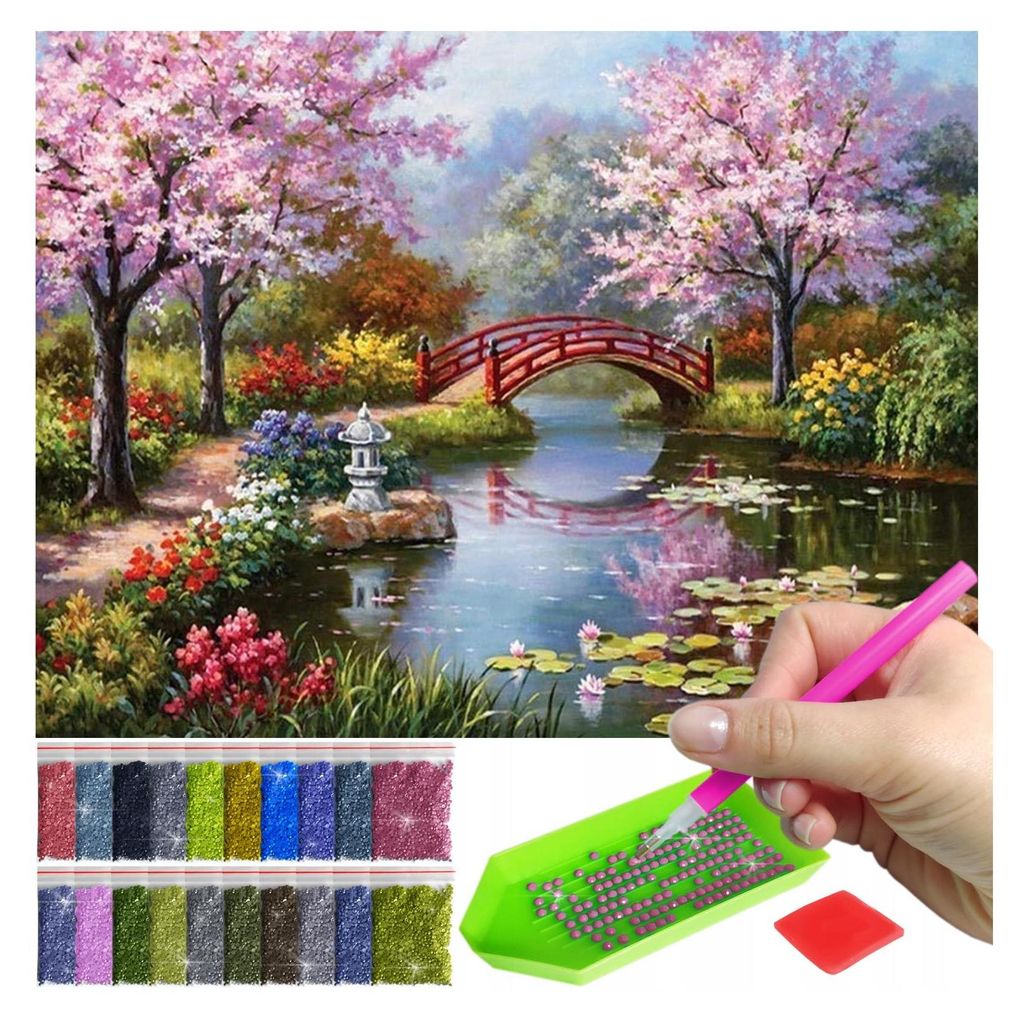 A diamond painting kit with a landscape image and accessories.
