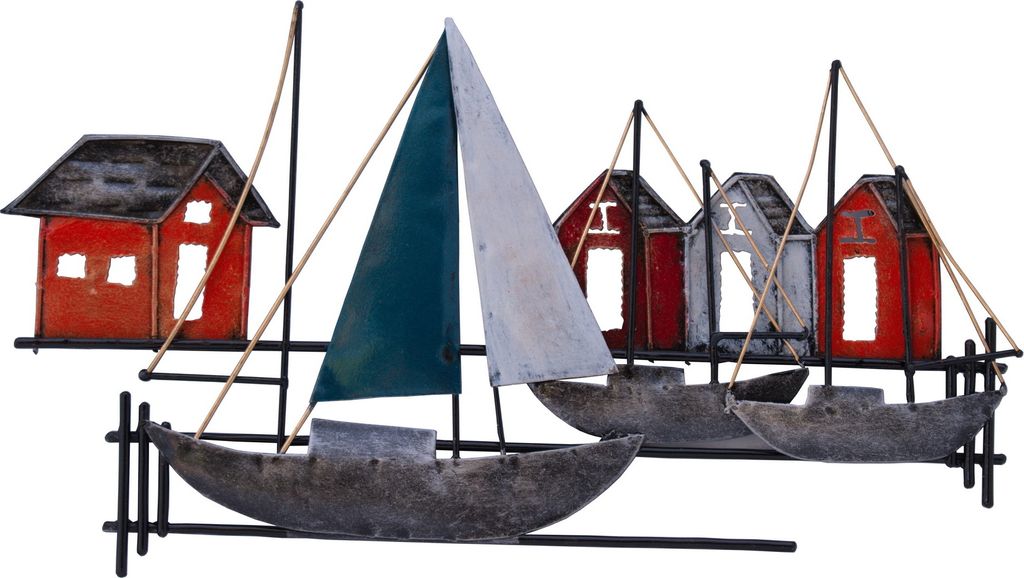 A metal wall decoration depicting a maritime scene with sailboats and houses.