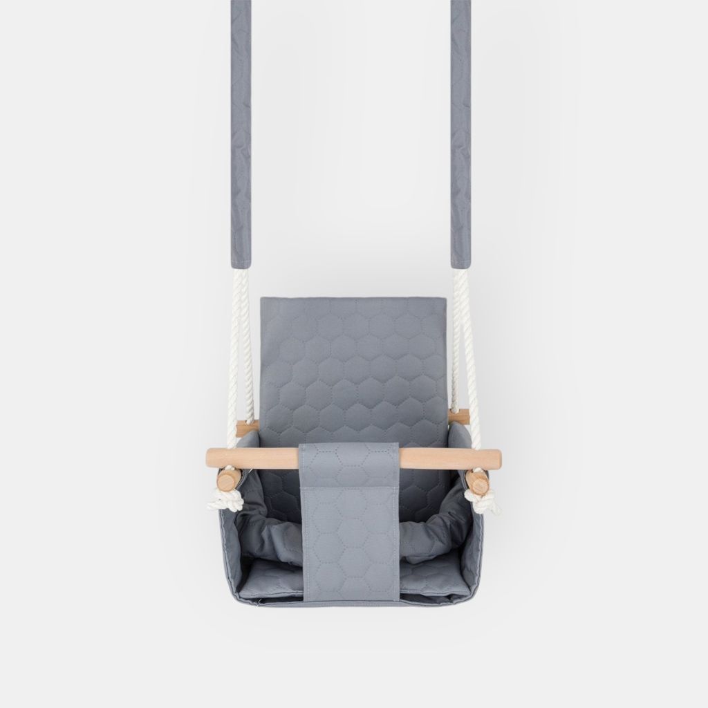 A baby swing seat is shown hanging against a white background.