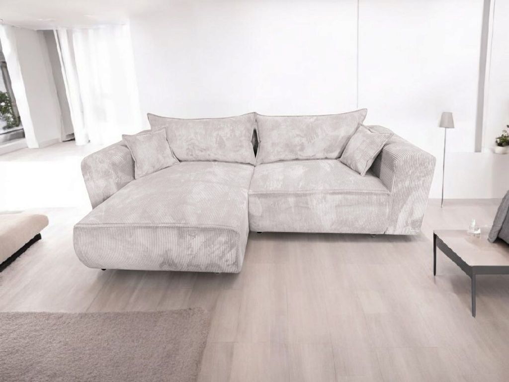 A sectional sofa is shown in a bright, modern living room setting.