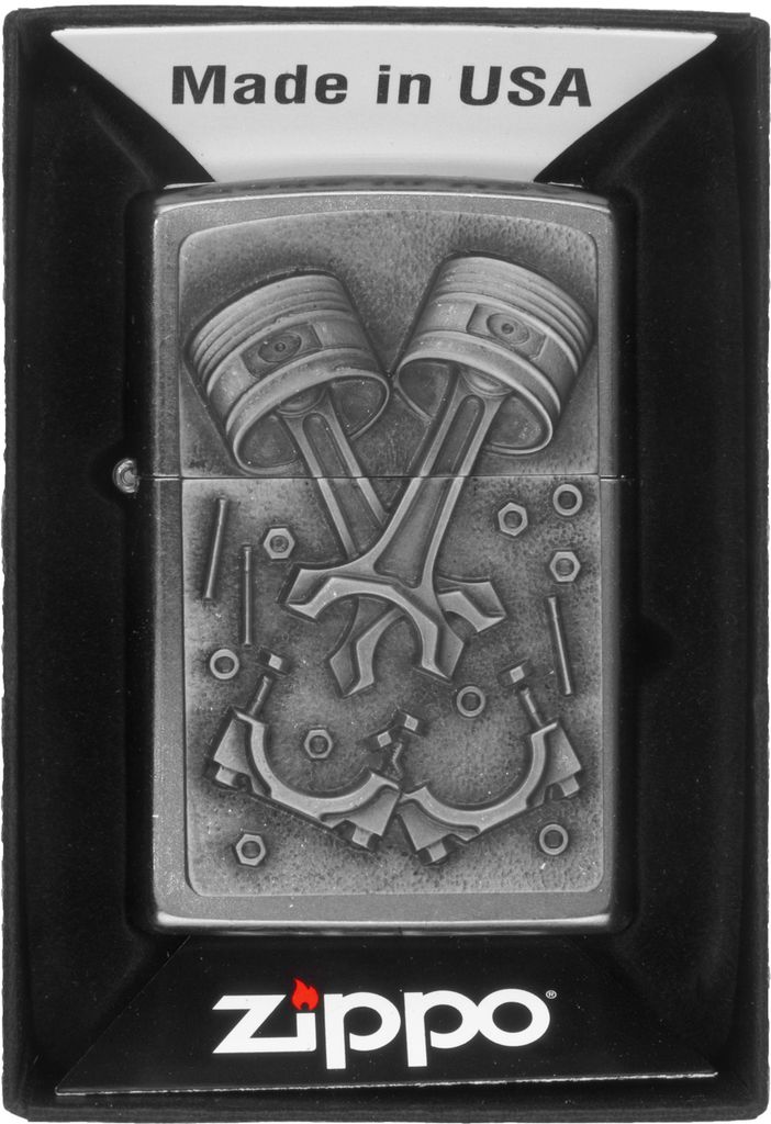 A Zippo lighter with an engine parts design, presented in its packaging.