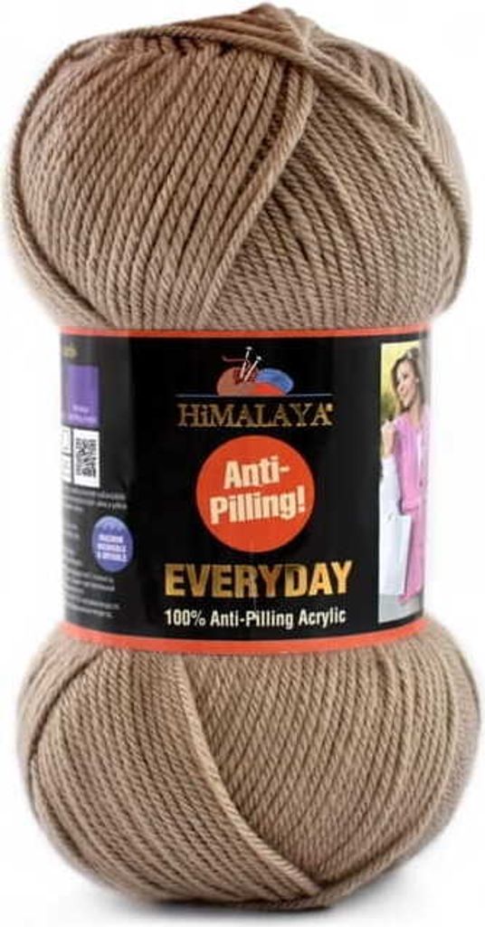 A ball of beige yarn with a product label wrapped around it.