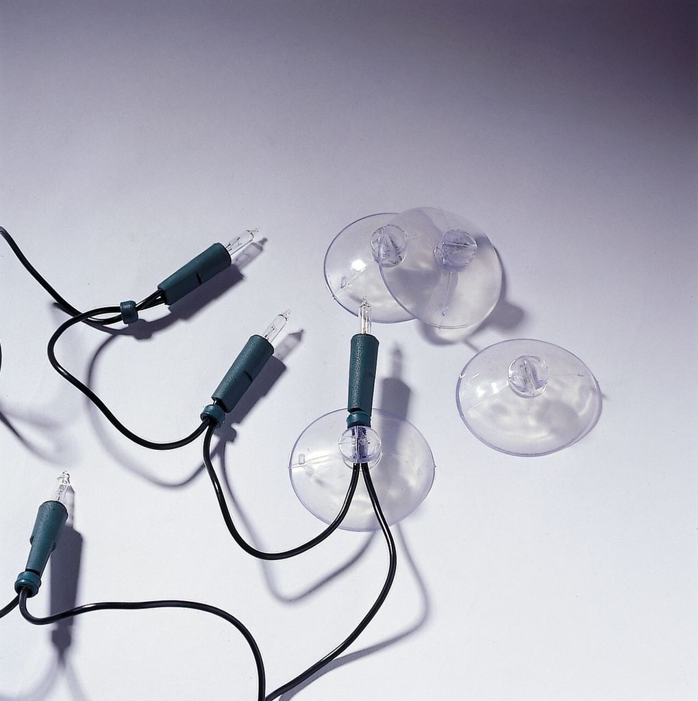 A close-up shot of several suction cups attached to a string of Christmas lights.
