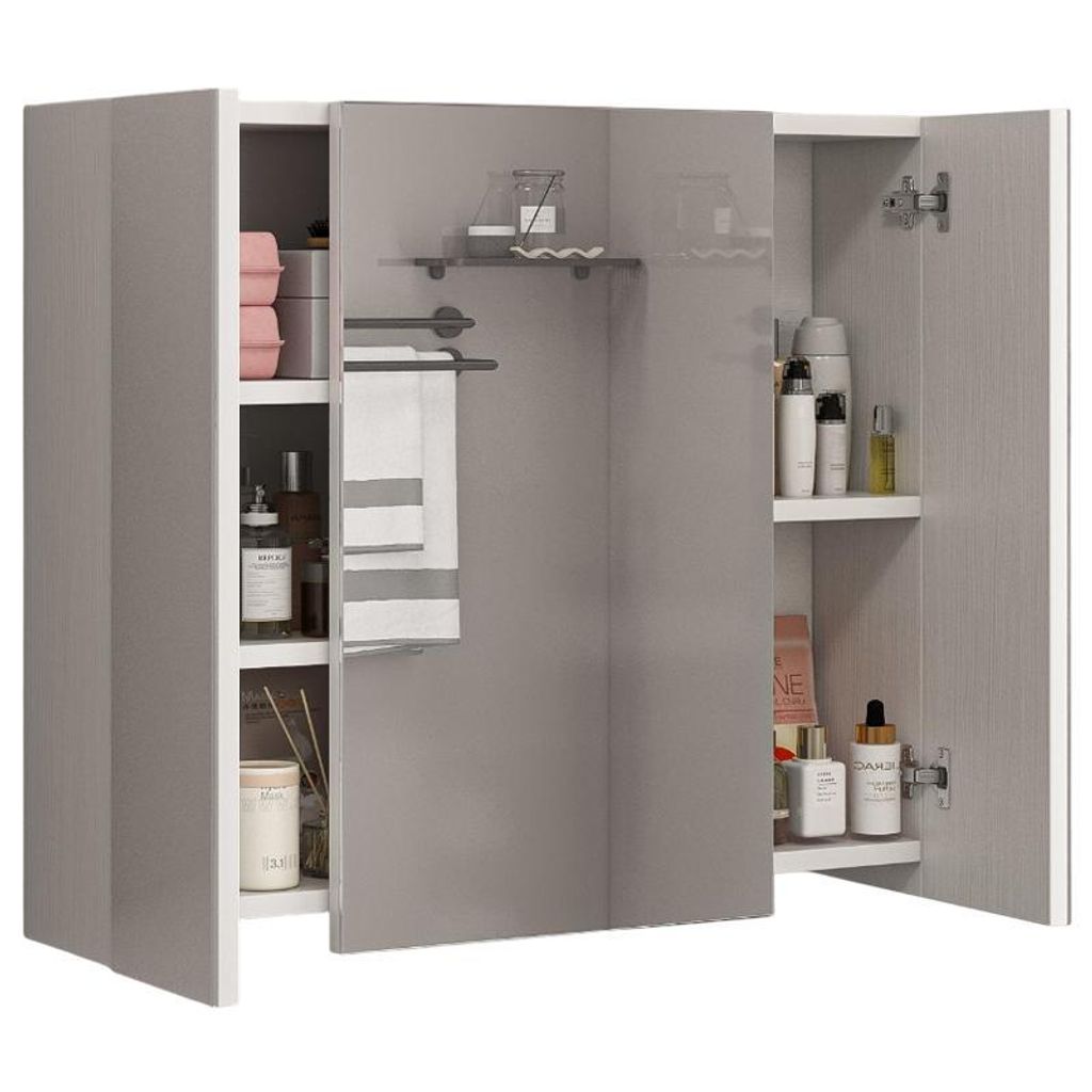 A bathroom cabinet with a three-part mirror and various toiletries and towels inside.