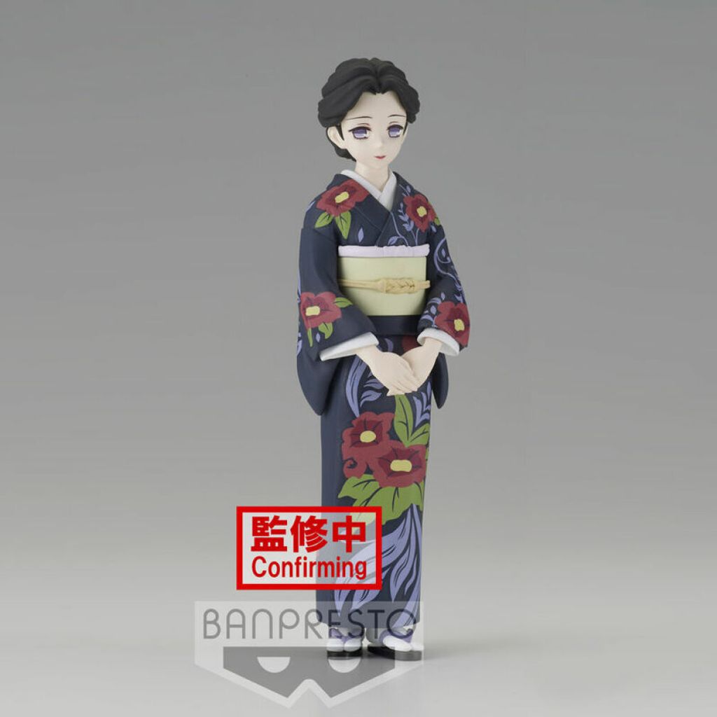 A figurine of a woman in a kimono against a plain background.