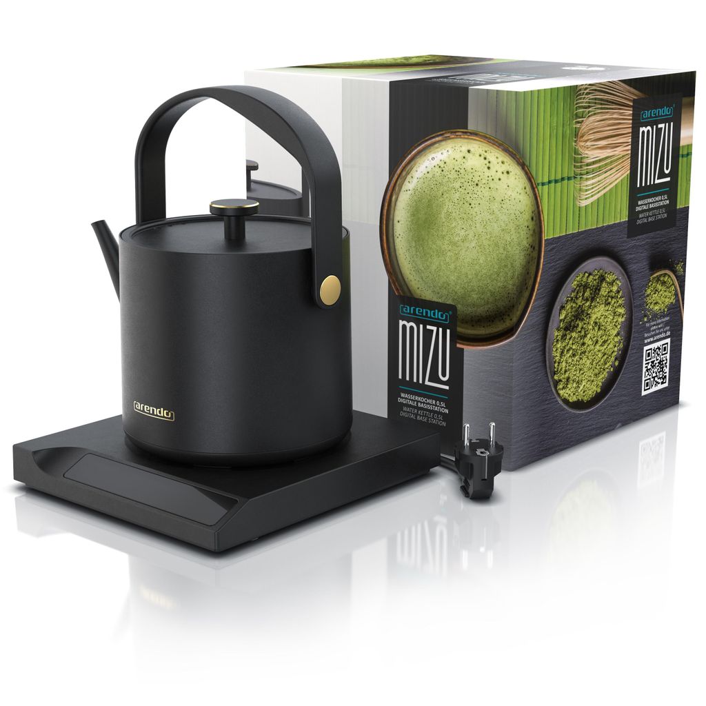 A black electric kettle and its packaging are displayed on a reflective surface.