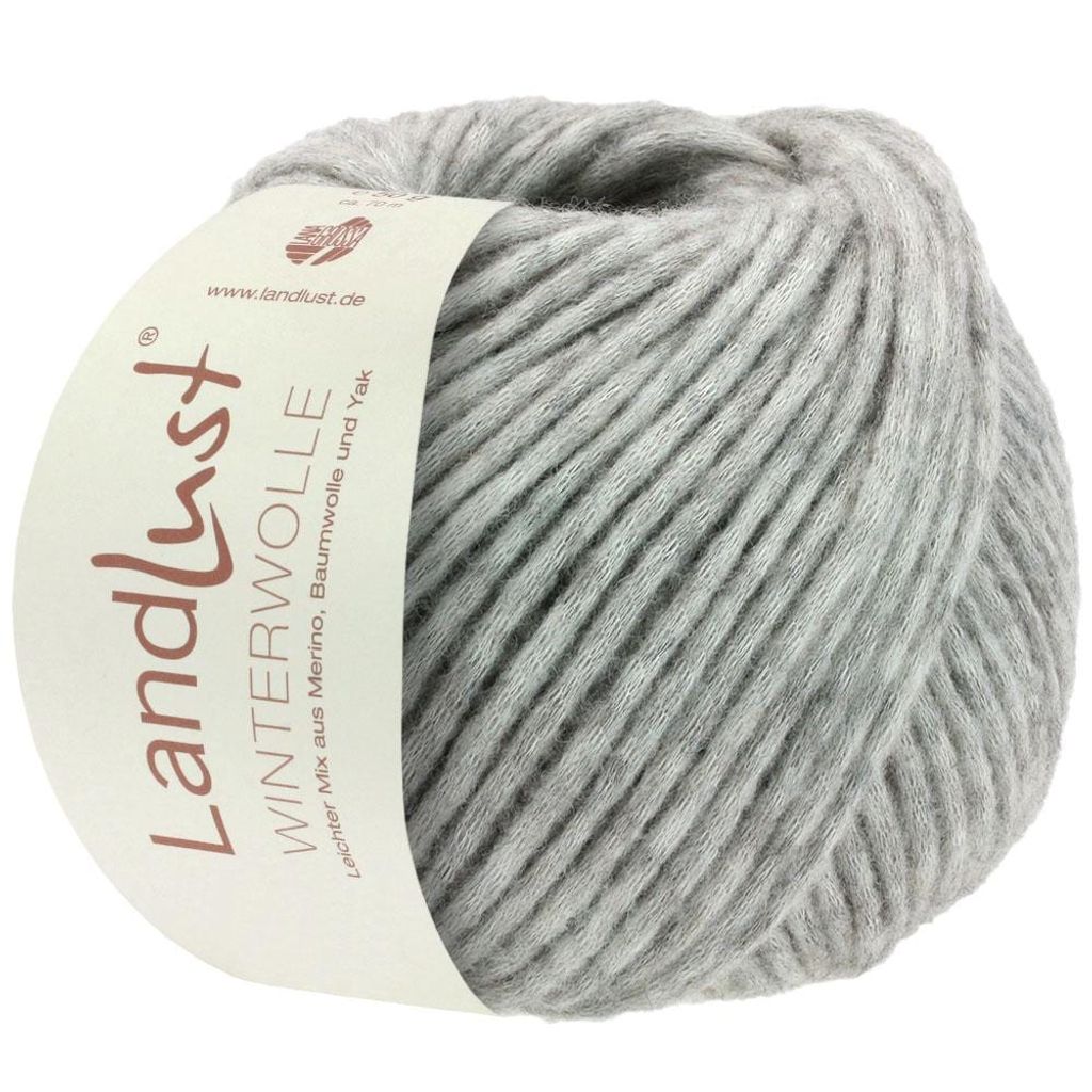 A ball of light gray yarn with a label attached.