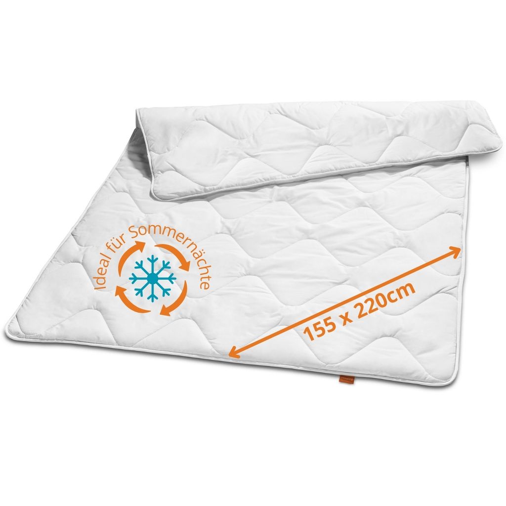 A white quilted comforter is laid out diagonally on a white background.