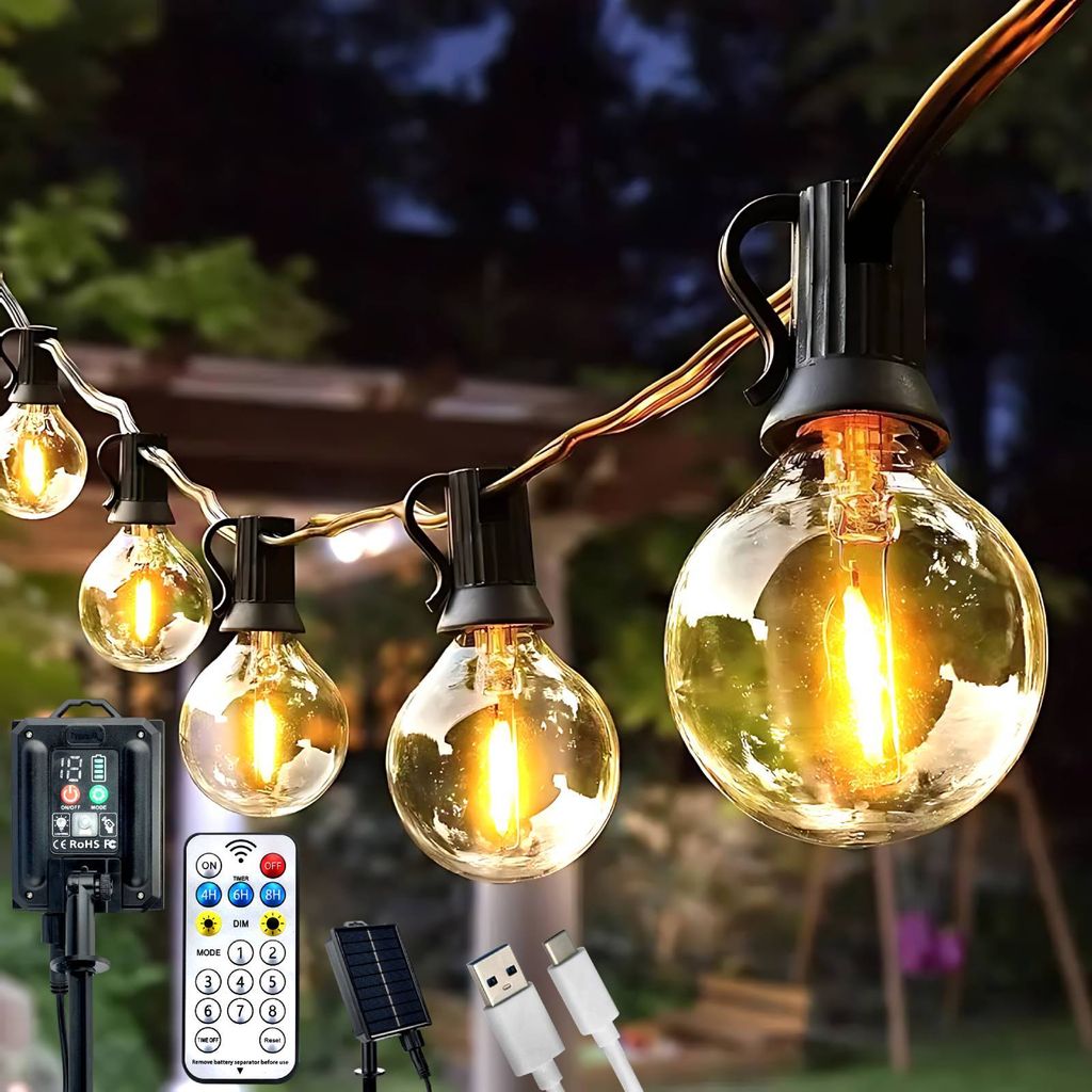 String lights hanging outdoors at dusk, with a solar panel, remote control, and USB cables in the foreground.