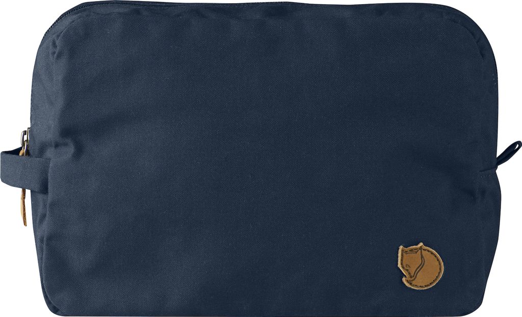 A navy blue toiletry bag with a brown logo.