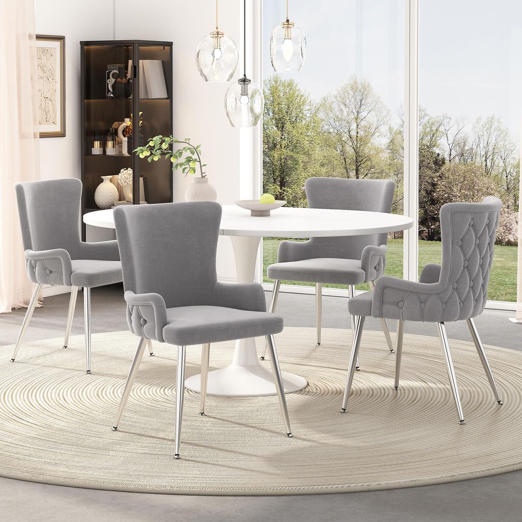 A dining room setting with a round table and four chairs.