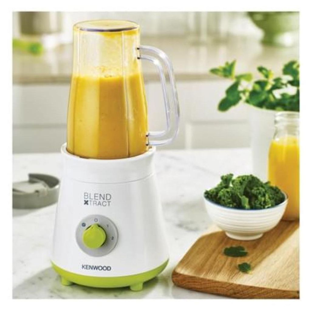 A Kenwood Blend Xtract smoothie maker is shown on a kitchen counter with ingredients for a smoothie.