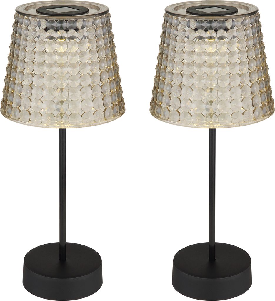 Two solar-powered table lamps with textured glass shades and black bases.