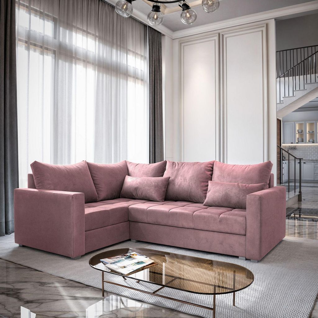 A pink sectional sofa is shown in a well-lit living room with sheer curtains and a glass coffee table.