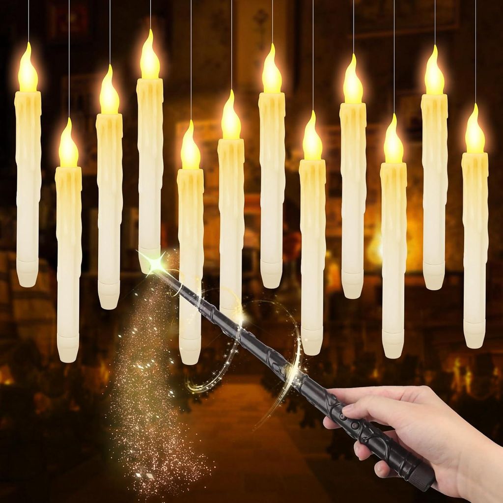 A hand holding a magic wand, with a trail of glitter, in front of a row of hanging LED candles.