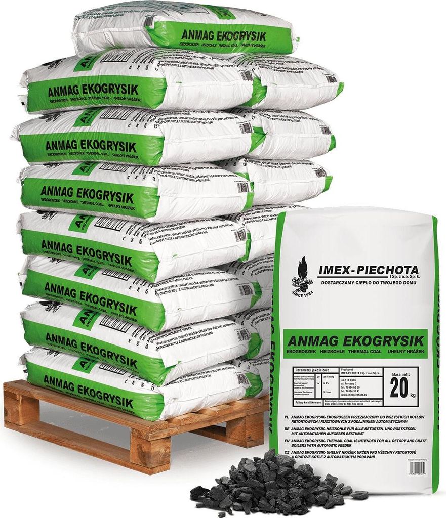 A stack of bags of coal on a pallet, with a single bag and some loose coal in the foreground.