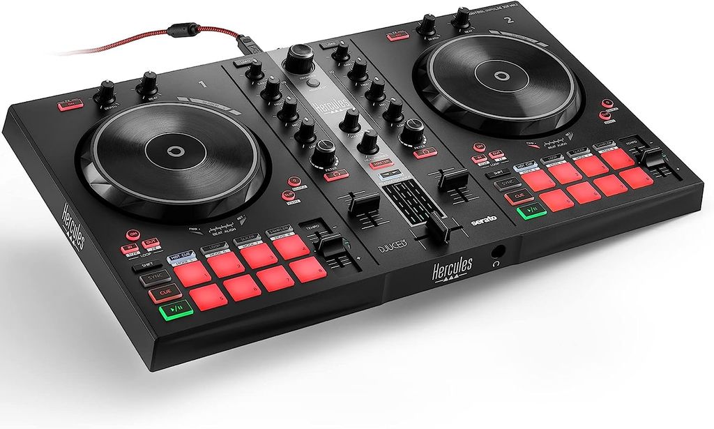 A black DJ controller with illuminated red and green buttons and silver knobs, shown from a slightly elevated diagonal angle against a white background.
