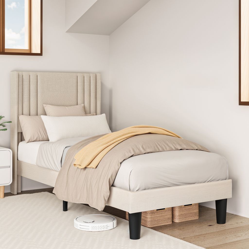 A bedroom scene with a single bed and bedding.