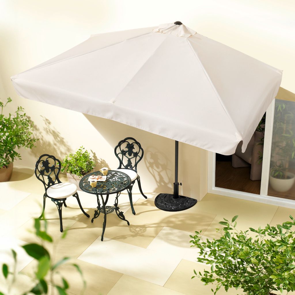 An outdoor patio scene with a table, chairs, and a large umbrella.