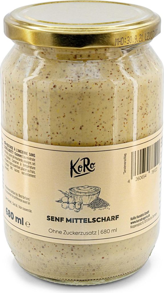 A glass jar of mustard with a label.