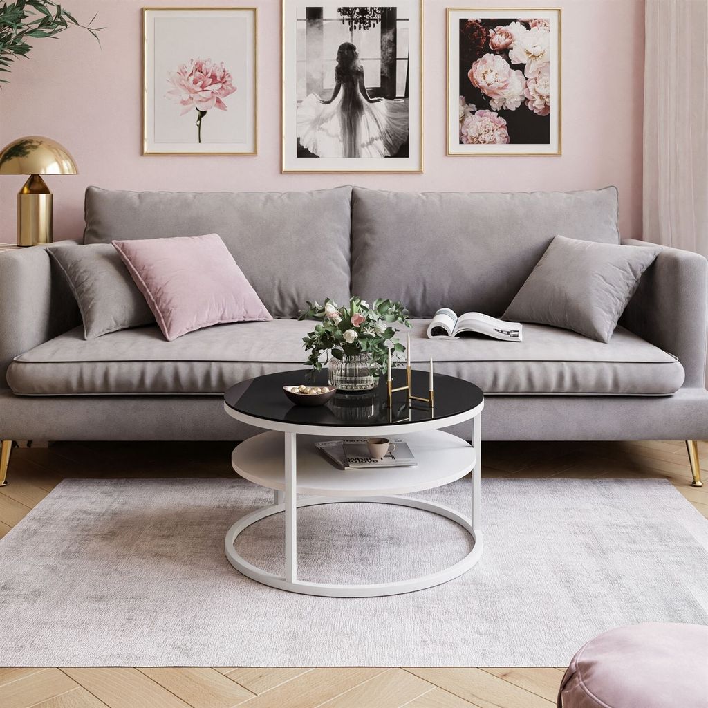 A living room scene with a sofa, coffee table, and artwork.