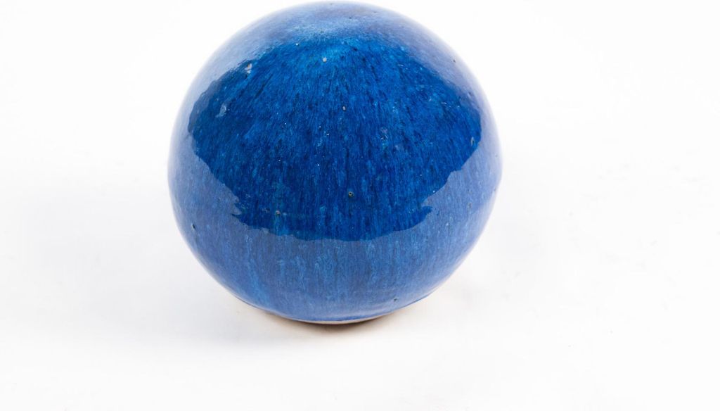A single blue ceramic garden ball on a white background.