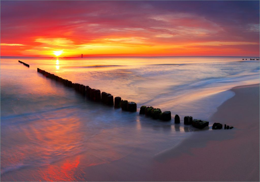Wallario selbstklebendes Poster - Farbenspiel im Himmel - Sonnenuntergang am Strand, Größe: 70 x 100 cm