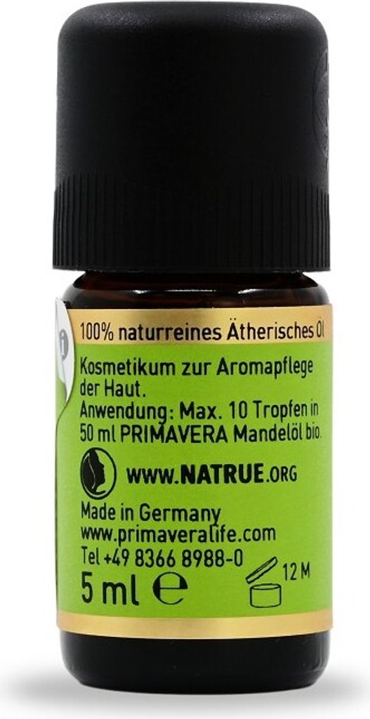 A close-up of a small glass bottle with a black cap, featuring a green label with product information.